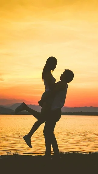 Boy Lifting Girl Romantic Sunset
